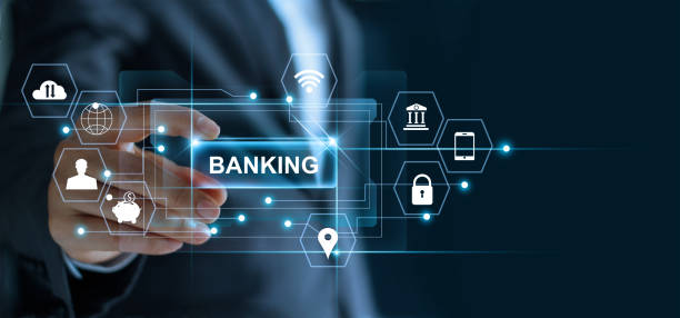 Businessman holding word banking in hand with icon network connection on virtual screen dark background Businessman holding word banking in hand with icon network connection on virtual screen dark background bank financial building stock pictures, royalty-free photos & images