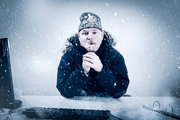 Businessman in a Cold Office with Snow and Ice stock photo