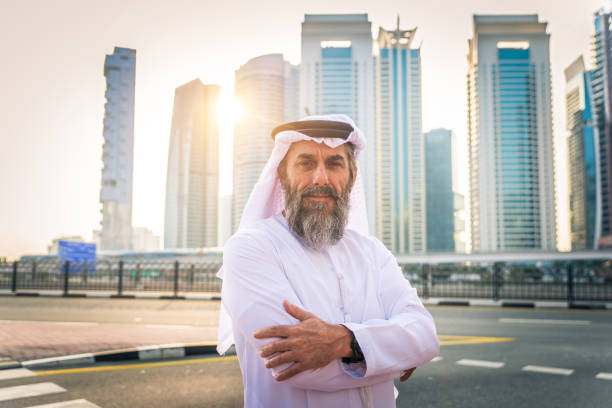 Businessman in Dubai Middle-eastern senior man with traditional kandora in Dubai old arab man stock pictures, royalty-free photos & images