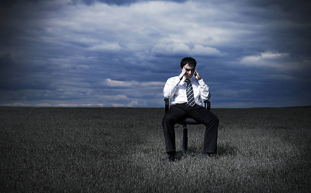Businessman in the meadow stock photo