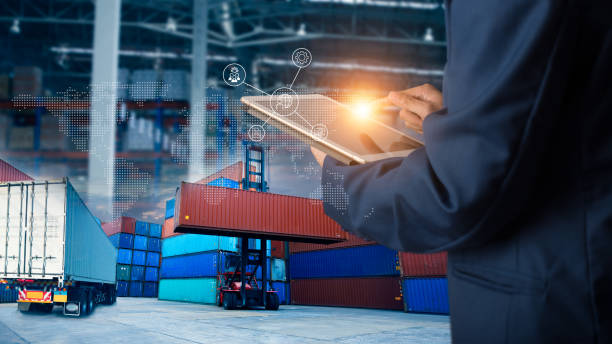 Businessman manager using laptop check orders online goods worldwide for network with Modern Trade warehouse logistics. Industry of logistics network concept. stock photo