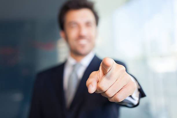 Businessman pointing his finger at you stock photo
