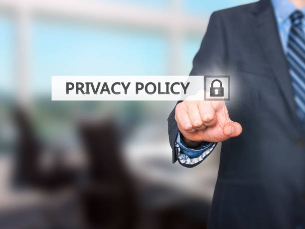 Businessman pressing Privacy Policy button on virtual screens stock photo