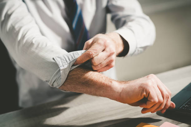 Businessman rolling up his sleeves stock photo