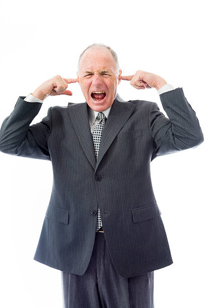 Businessman screaming in frustration Businessman screaming in frustration Fingers in Ears stock pictures, royalty-free photos & images