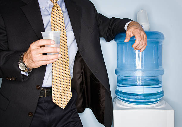 Businessman Standing at the Water Cooler stock photo