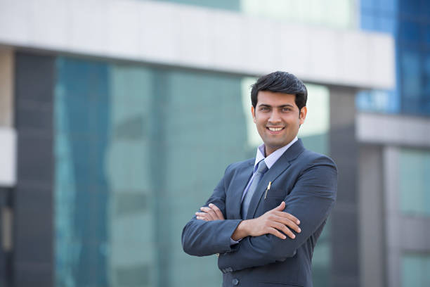 Businessman Standing With His Arms Folded - Stock image Businessman, Men, Professional Occupation, Suit indian ethnicity stock pictures, royalty-free photos & images