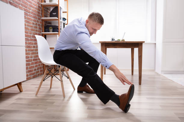 businessman stretching his leg and hand in office - business man shoes on desk imagens e fotografias de stock