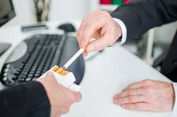 Businessman taking a cigarette stock photo