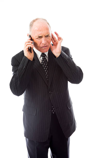 Businessman talking on a mobile phone Businessman talking on a mobile phone Fingers in Ears stock pictures, royalty-free photos & images