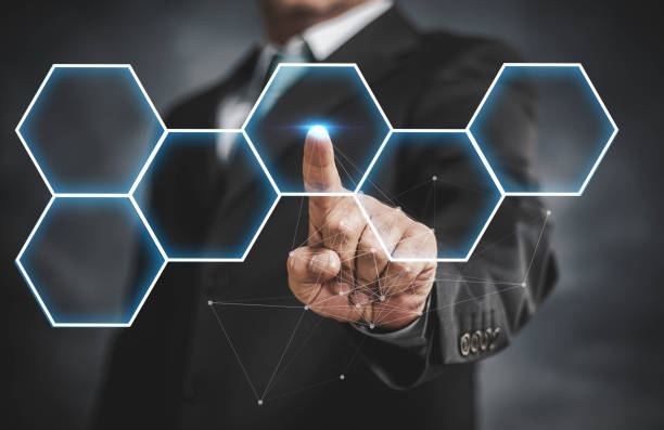 businessman touching virtual screen on hexagon stock photo
