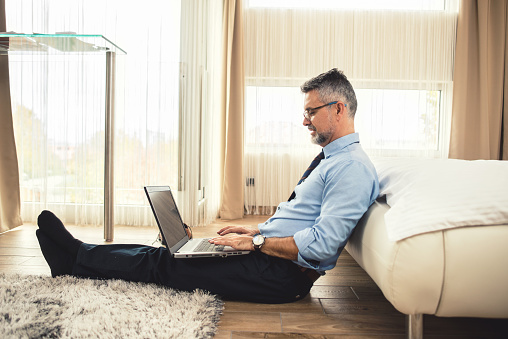 Businessman Using A Laptop In Hotel Room Stock Photo - Download Image ...