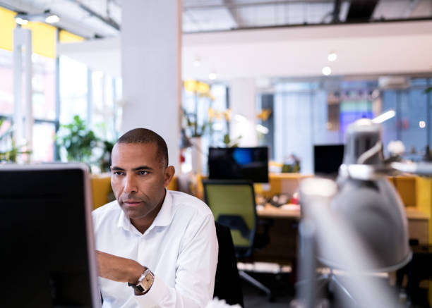 Businessman using computer in new office stock photo