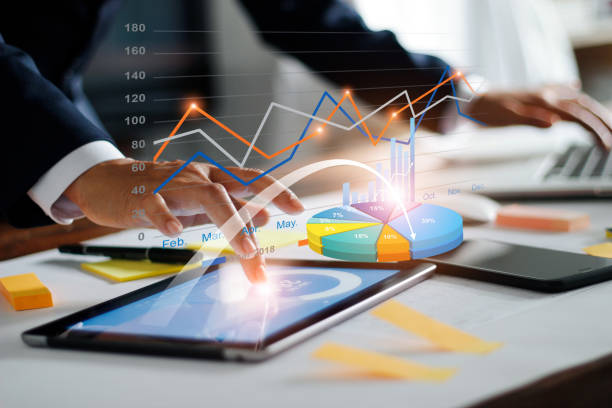 Businessman using tablet and laptop analyzing sales data and economic growth graph chart. Business strategy. Digital marketing. Business innovation technology concept stock photo