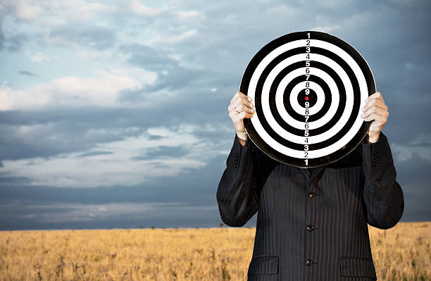 Businessman with darts outdoors stock photo