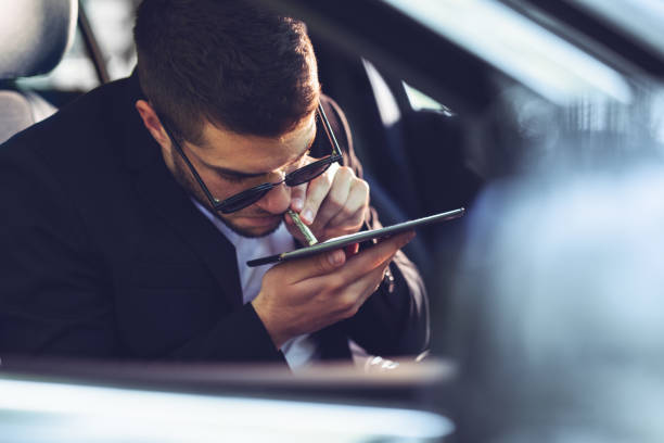 Businessman with drug addiction sniffing cocaine from tablet Businessman with drug addiction sniffing cocaine from tablet snorting stock pictures, royalty-free photos & images