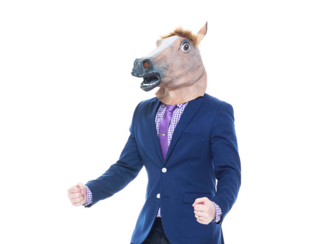 Businessman with horse mask is dancing Handsome businessman in blue jacket and wearing jeans horse mask photos stock pictures, royalty-free photos & images