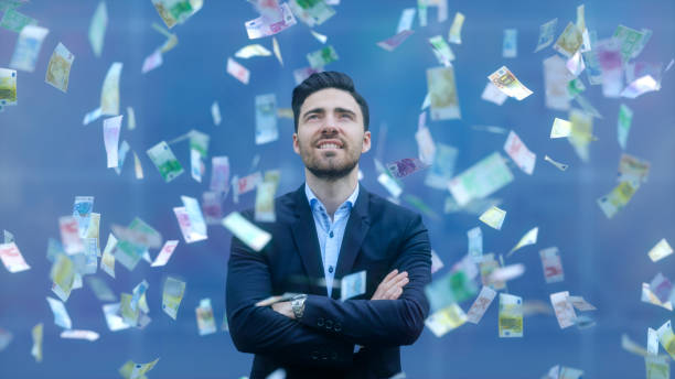 Businessman with raining banknotes Businessman with raining banknotes. money rain stock pictures, royalty-free photos & images