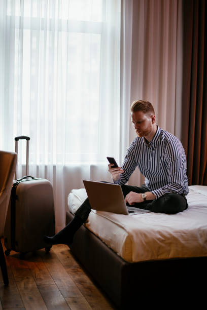 Businessman working in hotel room stock photo