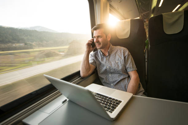businessman working mobile during traveling by train - businessman train working imagens e fotografias de stock