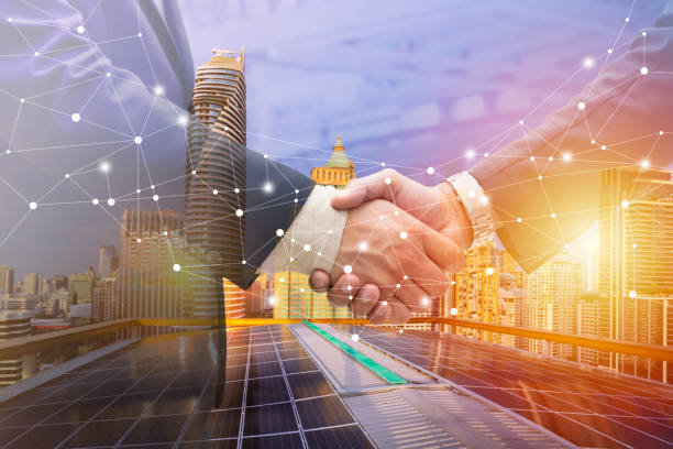 Businessmen are shaking hands for business venture and Marketing on energy.Solar is needed in the future.Solar panels require expertise in installation.photovoltaics to the business sector. stock photo
