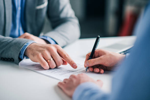 Businessmen hand's pointing where to sign a contract, legal papers or application form. Businessmen hand's pointing where to sign a contract, legal papers or application form. form filling stock pictures, royalty-free photos & images