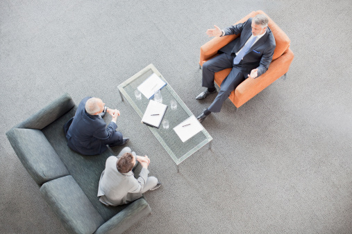 Businessmen Meeting In Lobby Stock Photo - Download Image Now - iStock