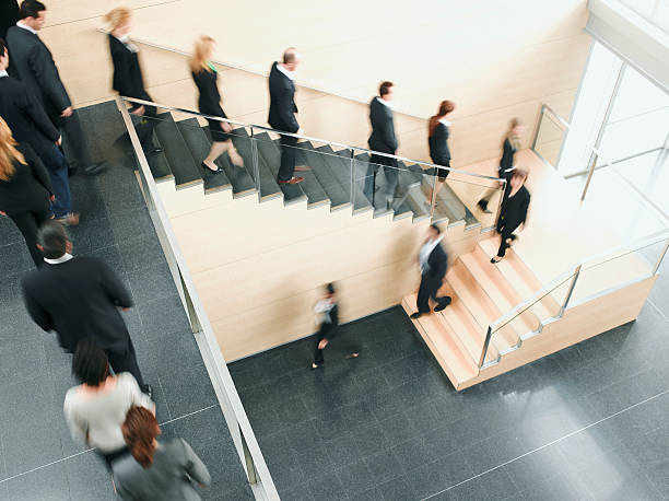 Businesspeople walking down office staircase  downsizing unemployment photos stock pictures, royalty-free photos & images