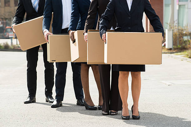 Businesspeople With Cardboard Boxes Standing In A Line Close-up Of Businesspeople With Cardboard Boxes Standing In A Line;Outdoor downsizing unemployment stock pictures, royalty-free photos & images