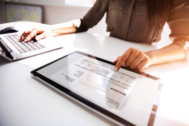 Businesswoman Checking Invoice On Digital Tablet Close-up Of A Busineswoman's Hand Working With Invoice On Digital Tablet check financial item stock pictures, royalty-free photos & images