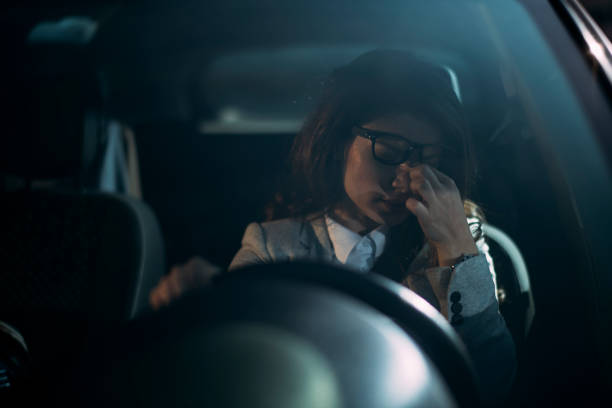 Businesswoman, Driving car, Tired. Sleepy businesswoman driving her car stock photo