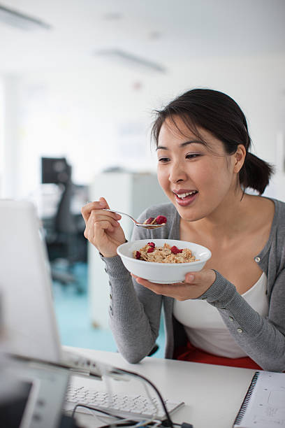 744 Asian Person Working While Eating In Office Stock Photos, Pictures &  Royalty-Free Images - iStock