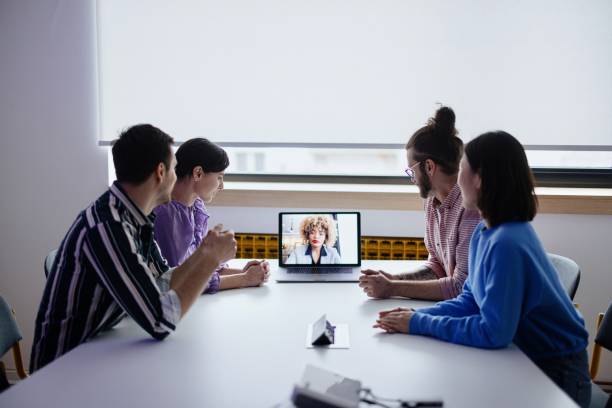 Businesswoman having online briefing with team in a hybrid office stock photo
