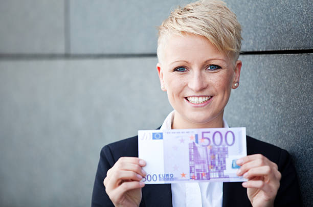 Businesswoman holding 500 euro stock photo