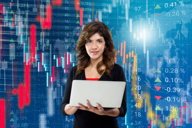 Businesswoman holding laptop in front of stock market data background Businesswoman holding laptop in front of virtual interface of stock market data background business market stock pictures, royalty-free photos & images