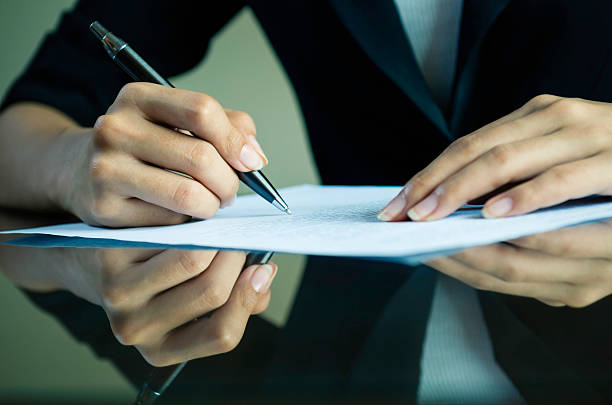 A businesswoman signing a contract stock photo