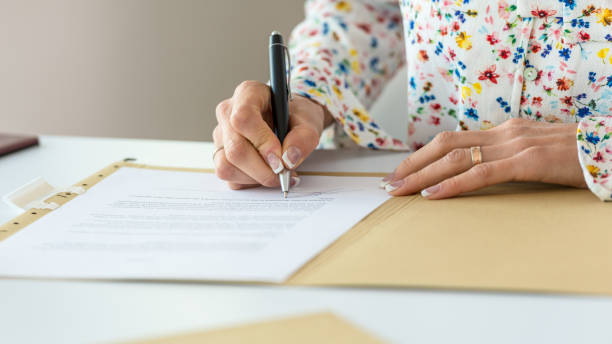 Businesswoman signing contract stock photo