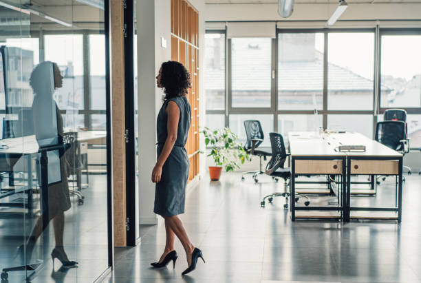 Businesswoman walking in modern office. stock photo