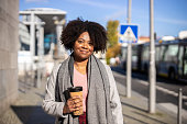 istock Businesswoman with a coffee cup in the city 1301773880