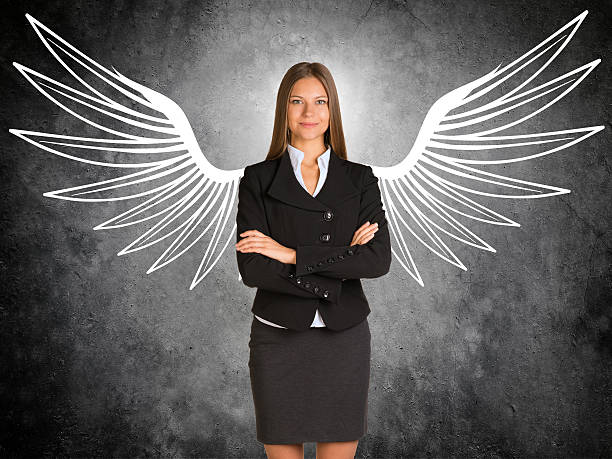 Businesswoman with drawn angel wings stock photo