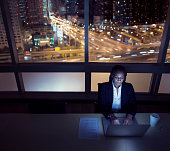 istock Businesswoman working on laptop at night in office downtown 637925406