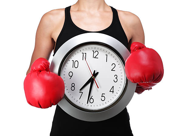 bust of a woman boxer with a clock stock photo