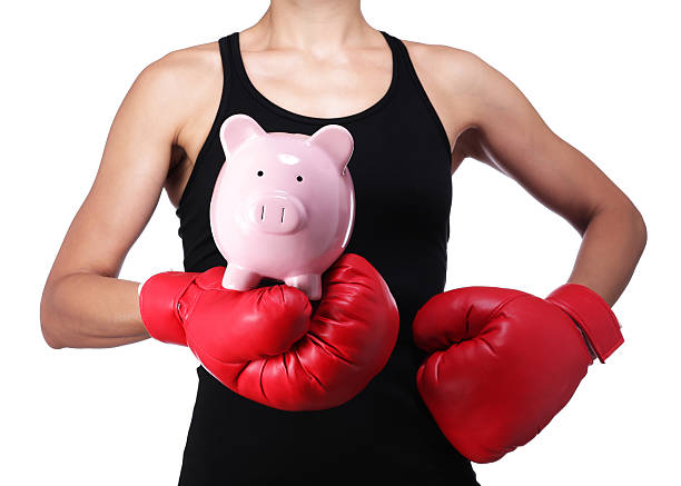 bust of a woman boxer with a piggy bank stock photo