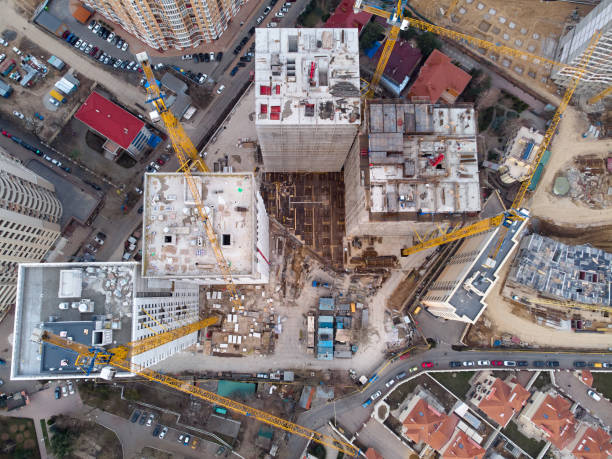 Busy Construction Site and Construction Equipment Aerial Photo at sunset stock photo