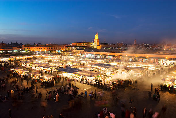 Busy market in a large city lit up at night stock photo