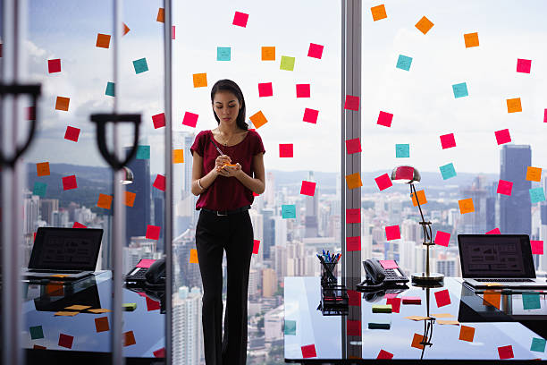 Busy Person Writing Many Sticky Notes On Large Window Mixed race secretary working in modern office in skyscraper, writing and sticking adhesive notes with tasks on window. chores photos stock pictures, royalty-free photos & images