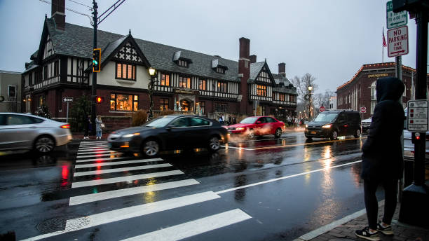 Busy Post road in downtown area in rainy afternoon on week before Christmas with Anthropologie store building stock photo