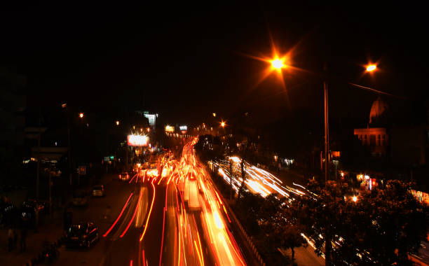A busy road at night in New Delhi, India stock photo