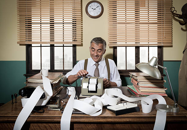 Busy vintage accountant with calculator Busy vintage accountant with adding machine surrounded by cash register tape. plus sign photos stock pictures, royalty-free photos & images