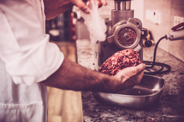 Butcher Preparing the Minced Meat stock photo